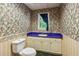 Charming half-bath with unique floral wallpaper and blue countertop at 11637 Brown Bridge Rd, Covington, GA 30016