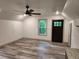 Bedroom showcasing wood-look floors, a ceiling fan, and a dark door with a multi-pane window at 11637 Brown Bridge Rd, Covington, GA 30016