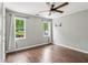 Bright bedroom featuring hardwood flooring and a large window with natural light at 11637 Brown Bridge Rd, Covington, GA 30016