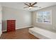 Bedroom featuring a red dresser, a window for natural light and wood-look flooring at 11637 Brown Bridge Rd, Covington, GA 30016