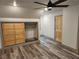 Bedroom features wood-look floors, ceiling fan, closet with wood doors, and built-ins at 11637 Brown Bridge Rd, Covington, GA 30016