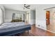 This bright bedroom features wood floors, neutral walls, and a barn door leading to an en-suite at 11637 Brown Bridge Rd, Covington, GA 30016