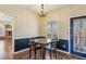 Eat-in kitchen area features hardwood floors, half wall trim, a modern light fixture, and a window at 11637 Brown Bridge Rd, Covington, GA 30016