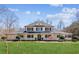 Charming two-story home with a welcoming porch, lush lawn, and beautiful architectural details at 11637 Brown Bridge Rd, Covington, GA 30016