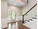 Grand foyer featuring wood floors, staircase, and decorative front door with sidelights at 11637 Brown Bridge Rd, Covington, GA 30016