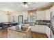 Bright kitchen features white cabinets, a decorative backsplash and a center island at 11637 Brown Bridge Rd, Covington, GA 30016