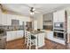 The stylish kitchen features white cabinets, an island and stainless steel appliances at 11637 Brown Bridge Rd, Covington, GA 30016