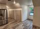 View of kitchen with stainless refrigerator and built in cabinet storage at 11637 Brown Bridge Rd, Covington, GA 30016