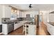 Bright kitchen with stainless steel appliances, island, and tile backsplash at 11637 Brown Bridge Rd, Covington, GA 30016