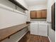 Laundry room with shelving, cabinets, a folding table, washer, and dryer at 11637 Brown Bridge Rd, Covington, GA 30016