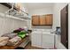 Functional laundry room with washer, dryer, folding counter and cabinet storage at 11637 Brown Bridge Rd, Covington, GA 30016