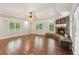 Spacious living room featuring a stone fireplace, wood-look floors, and abundant natural light at 11637 Brown Bridge Rd, Covington, GA 30016