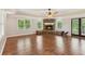 Spacious living room featuring a stone fireplace, wood-look floors, and abundant natural light at 11637 Brown Bridge Rd, Covington, GA 30016