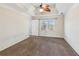 Expansive main bedroom featuring carpet floors, a ceiling fan, and a tray ceiling at 11637 Brown Bridge Rd, Covington, GA 30016