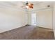 Spacious main bedroom with carpet, ceiling fan, tray ceiling and ensuite bath at 11637 Brown Bridge Rd, Covington, GA 30016