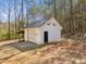 Exterior shot of outbuilding showing siding, roof, door, and outdoor storage at 11637 Brown Bridge Rd, Covington, GA 30016