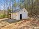 Small white outbuilding with a lean-to and single door at 11637 Brown Bridge Rd, Covington, GA 30016