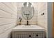 Stylish powder room with white wood paneling and modern fixtures at 11637 Brown Bridge Rd, Covington, GA 30016