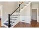 Classic staircase featuring dark wood treads, painted risers and paneled walls at 11637 Brown Bridge Rd, Covington, GA 30016