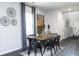 Modern dining room featuring a wooden table, black chairs, and stylish decor at 1221 Arnhem Dr, Hampton, GA 30228