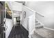 Welcoming foyer with dark wood floors, a staircase, and a view into the dining area at 1221 Arnhem Dr, Hampton, GA 30228