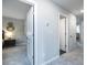 Hallway view with gray walls, white doors, and neutral carpet, leading to multiple rooms in the home at 1221 Arnhem Dr, Hampton, GA 30228