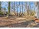 Spacious backyard with mature trees providing shade and privacy for outdoor enjoyment at 1350 Bluefield Sw Dr, Atlanta, GA 30310