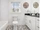 Well-lit bathroom featuring subway tile, granite countertop, and tile floor at 1350 Bluefield Sw Dr, Atlanta, GA 30310