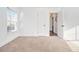 Bright bedroom featuring neutral carpet and freshly painted white walls with ample natural light from the window at 1350 Bluefield Sw Dr, Atlanta, GA 30310