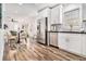 Modern kitchen featuring stainless steel appliances, white cabinets, and a dining area with a decorative wood floor at 1350 Bluefield Sw Dr, Atlanta, GA 30310