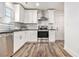 Modern kitchen featuring stainless steel appliances, white cabinets, and a subway tile backsplash at 1350 Bluefield Sw Dr, Atlanta, GA 30310