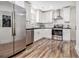 Modern kitchen featuring stainless steel appliances, white cabinets, and stylish countertops at 1350 Bluefield Sw Dr, Atlanta, GA 30310