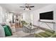 Bright living room featuring hardwood floors, stylish furniture, and a view of the modern kitchen at 1350 Bluefield Sw Dr, Atlanta, GA 30310