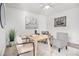 Bright home office with neutral walls, carpeted floors, modern furniture, and a large green plant at 1350 Bluefield Sw Dr, Atlanta, GA 30310