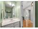 Bathroom with a white vanity and a large mirror, complemented by modern fixtures and neutral wall color at 2955 Victoria Park Dr, Buford, GA 30519