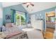 Bright bedroom with vaulted ceiling and a large window, complemented by light blue walls and white furniture at 2955 Victoria Park Dr, Buford, GA 30519