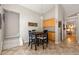 Cozy dining area featuring a black table, four chairs, and wood flooring at 2955 Victoria Park Dr, Buford, GA 30519