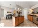 Spacious kitchen featuring an island with wooden cabinets and an adjacent dining area at 2955 Victoria Park Dr, Buford, GA 30519