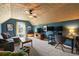 Attic living room featuring a vaulted ceiling, a comfortable seating area, and a modern workspace at 2955 Victoria Park Dr, Buford, GA 30519