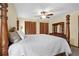 Primary bedroom with a four-poster bed, ceiling fan, and double closet with louvered doors at 425 Ridgemont Dr, Lawrenceville, GA 30046