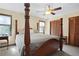 Spacious bedroom featuring a four-poster bed, double closet, and neutral walls at 425 Ridgemont Dr, Lawrenceville, GA 30046