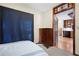 Cozy bedroom featuring a decorative glass door leading to a kitchen and an antique wooden dresser at 425 Ridgemont Dr, Lawrenceville, GA 30046