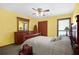 Bedroom featuring a four-poster bed, ceiling fan, and wooden dresser at 425 Ridgemont Dr, Lawrenceville, GA 30046