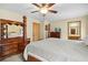 A primary bedroom with a four-poster bed, dresser with mirror, and ensuite bathroom access at 425 Ridgemont Dr, Lawrenceville, GA 30046