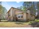 Exterior view of home surrounded by mature trees and an open lawn at 425 Ridgemont Dr, Lawrenceville, GA 30046