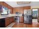 Kitchen featuring wooden cabinets, stainless steel appliances, and a view of the living room at 425 Ridgemont Dr, Lawrenceville, GA 30046