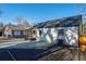 Renovated home featuring a large concrete patio and newly mulched flower beds under a clear blue sky at 1006 Byron Sw Dr, Atlanta, GA 30310