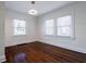 Bright bedroom with hardwood floors, pendant lighting, and natural light from two windows at 1006 Byron Sw Dr, Atlanta, GA 30310