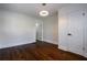 Bright bedroom with dark hardwood floors, white trim, and modern light fixture at 1006 Byron Sw Dr, Atlanta, GA 30310