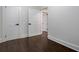 Bedroom with hardwood floors and white trim, showcasing multiple doors for easy access at 1006 Byron Sw Dr, Atlanta, GA 30310